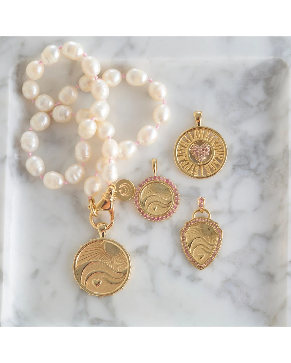 Jane Win Love–Courage–Strength original and cutout coin necklaces arranged together