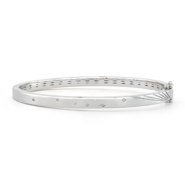 Adorn your wrist with the Mixed Metal Plain Diamond Bangle by Three Stories Jewelry. This sterling silver bracelet has diamond-shaped engravings, cutout designs with multi-colored tourmalines, and a secure hinge clasp for graceful elegance.