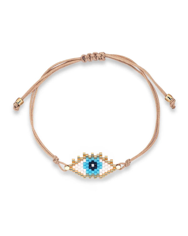 The Oiya Karina Miyuki Eye Bracelet features an adjustable beige cord and a blue, white, and gold evil eye bead design—ideal for lovers of unique, handmade accessories.