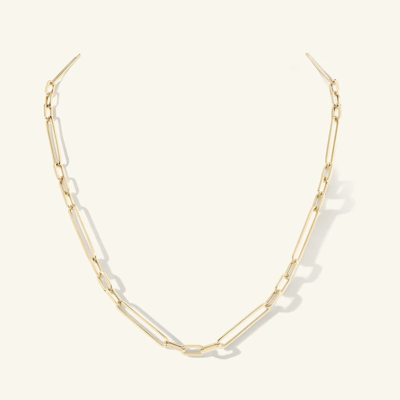 The 20 Mika Paperclip Chain Necklace by zahava, crafted from 14k gold with elongated rectangular links, is elegantly displayed against a plain white background. The necklace forms an open oval shape with two loose ends at the top, showcasing its elegant simplicity.