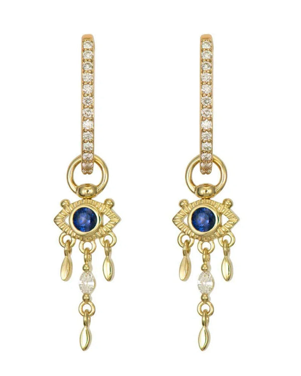 The Open Evil Eye Sapphire Charm earrings by Three Stories Jewelry feature 14K yellow gold hoops with pavé diamonds, open evil eye charms with blue sapphire centers, and dangling gold and diamond drops.