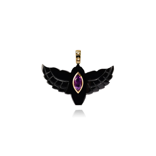 The Van Den Abeele Onyx Bird Pendant features black wing-like onyx with a central amethyst-like purple gemstone and a gold top accent for hanging. Its symmetrical design embodies the elegance typical of fine jewelry.