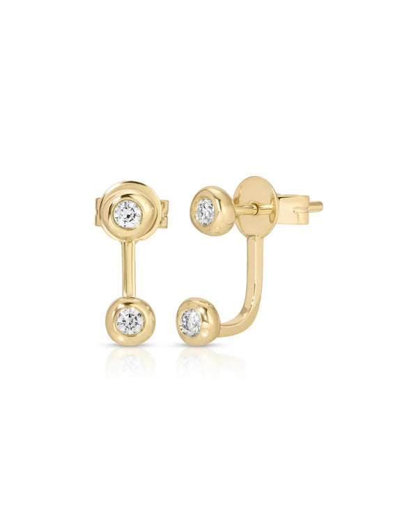 The ef collection Diamond Pillow Illusion Earrings feature two round, bezel-set diamonds on each gold stud—one on the post and one suspended below on a curved gold bar for a modern look.
