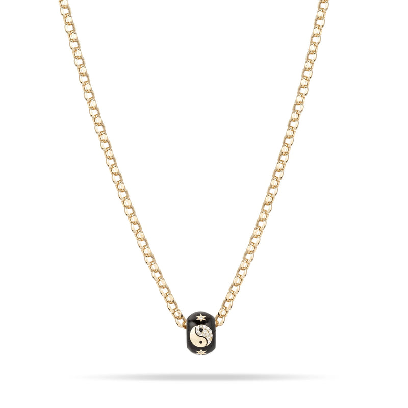 The Adina Reyter Zodiac Ceramic + Diamond Gemini Big Bead—a gold chain necklace with a black ceramic bead featuring a diamond-accented yin-yang and star—crafted in 14k gold, shown on a white background.