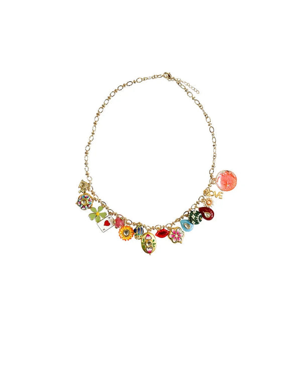 The Grigri Bold choker necklace by Monoki features gold plating and playful charms—flowers, a heart, four-leaf clover, red gem, dice, and a pink LOVE disc—making it a handcrafted statement piece perfect for any fun occasion.