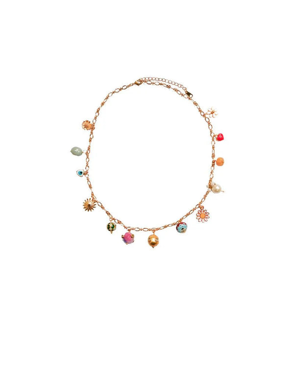 The Grigri Chain Short by Monoki is a gold-plated necklace featuring handcrafted charms—colorful beads, pearls, and floral shapes—evenly spaced along the chain and shown on a white background.