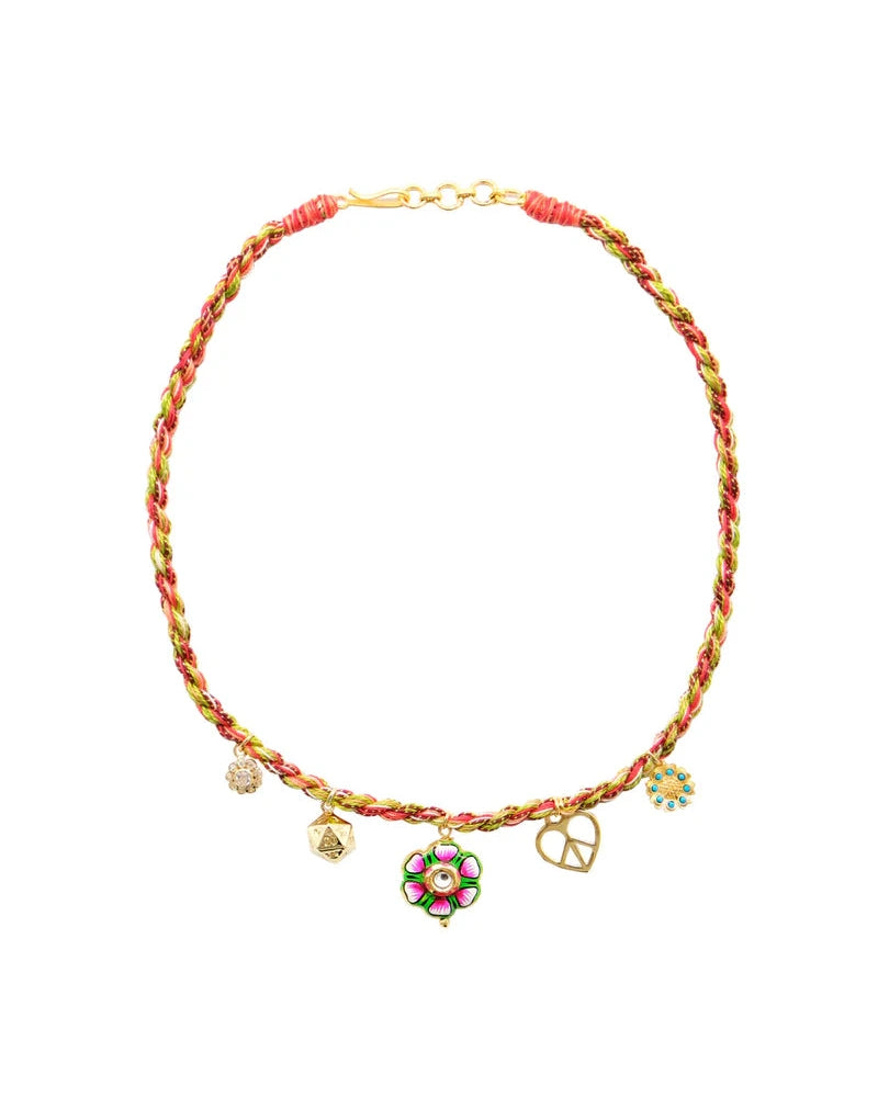 The Monoki Grigri Choker - Flower features pink, green, and gold braided threads with five gold-plated pendants—a flower, heart, star, and two round charms. This adjustable choker ensures a perfect fit.