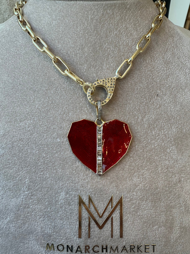 A gold chain necklace with a clasp features the Red Heart pendant by the woods, showcasing a textured red heart-shaped pendant adorned with a vertical row of rhinestones and bearing the Monarch Market logo.