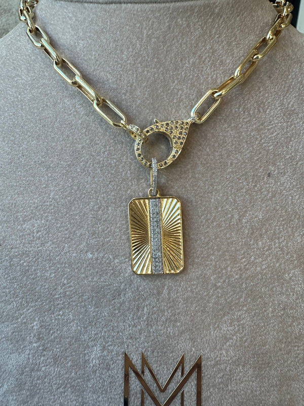 A 10k gold chain necklace, featuring The Woods Gold Rectangle Pendant, gleams elegantly with its textured design and central vertical strip of pave diamonds. The luxury piece is showcased on a neutral background, enhancing its allure.