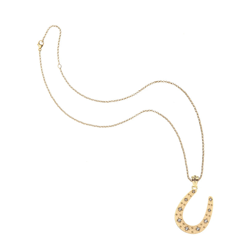 The Jane Win LUCKY Starry Horseshoe Pendant is a delicate 14k gold-plated sterling silver necklace featuring a shimmering white topaz horseshoe, shown on a white background.