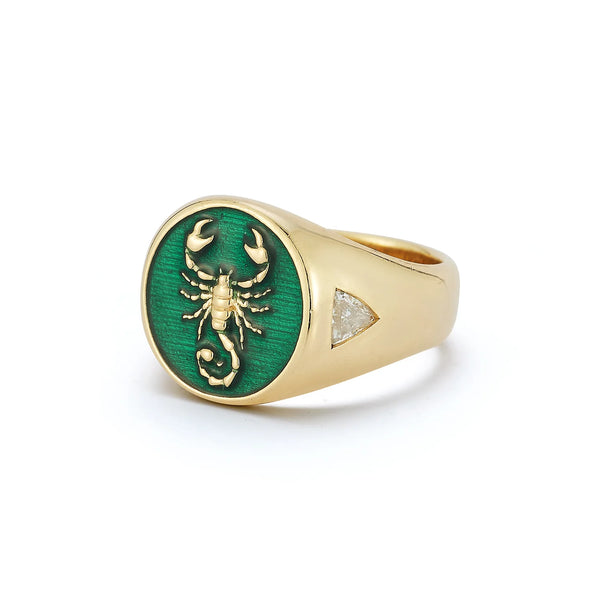 The Fearless Signet Ring by Kate Collins Jewelry is a 14K gold ring with a scorpion design on an emerald green enamel oval face, accented with lab-grown diamonds and featuring triangular textured side details.