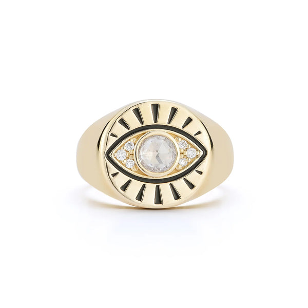 The Protection Signet Ring by Kate Collins Jewelry is a 14K gold piece featuring an eye talisman design, a central clear gemstone, rose-cut diamonds, and black accents for a captivating allure.