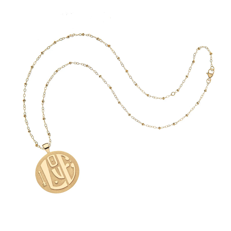 The Jumbo LOVE Pendant by Jane Win is a 14k gold plated chain necklace with a circular pendant featuring engraved Arabic calligraphy. Its visible clasp complements the polished, shiny look of this engravable jewelry on a plain white background.