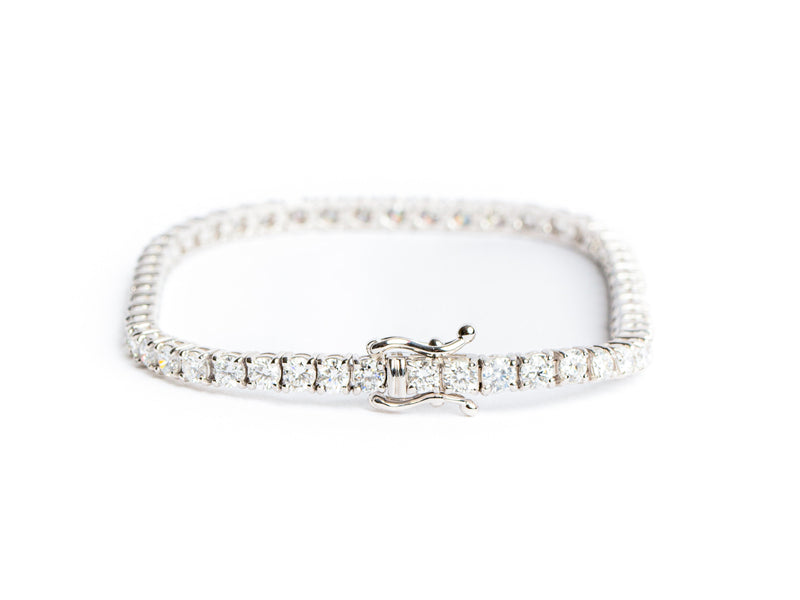 The Monarch Market Lab Grown Tennis Bracelet, sparkling in silver and encrusted with round diamonds, features a secure clasp against a plain white background.