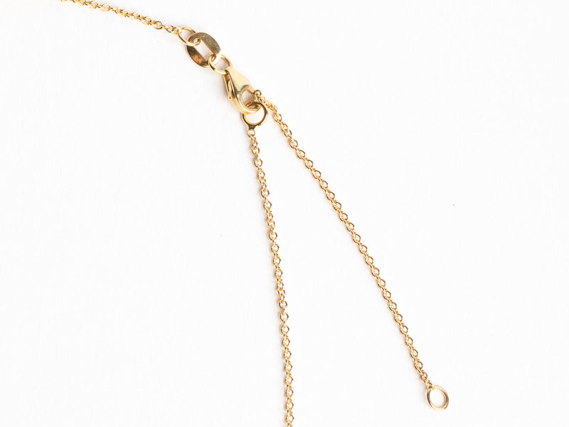 Close-up of the Monarch Market Lab Grown Small Gold Bezel Necklace on a white background. It features two delicate strands that join at a ring clasp, highlighting the intricate links of this elegant jewelry piece.