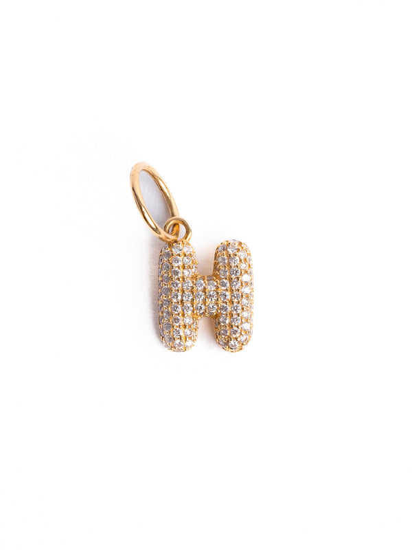 The Diamond Bubble Letter Charm by Monarch Market is a gold H pendant adorned with pave diamonds, featuring a small gold loop for attaching to a chain against a plain white background. Perfect for custom order jewelry lovers seeking personalized elegance.