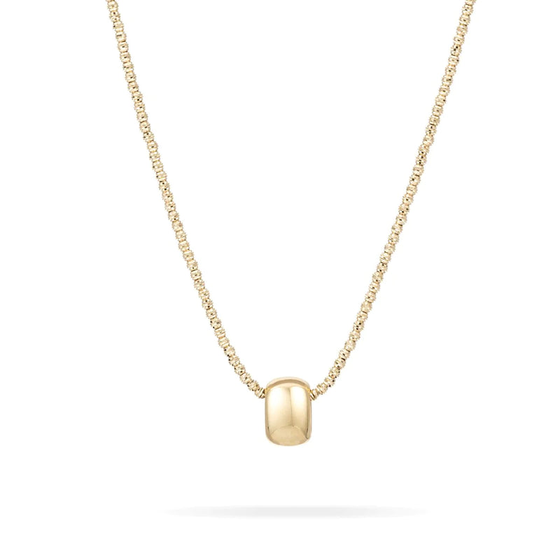 The Engravable Big Bead by Adina Reyter is a gold necklace featuring a simple chain with an oval pendant at the center. The 14k yellow gold pendant is smooth and polished, enhancing the minimalist design's elegance. The white background accentuates the necklace's radiant golden shine.