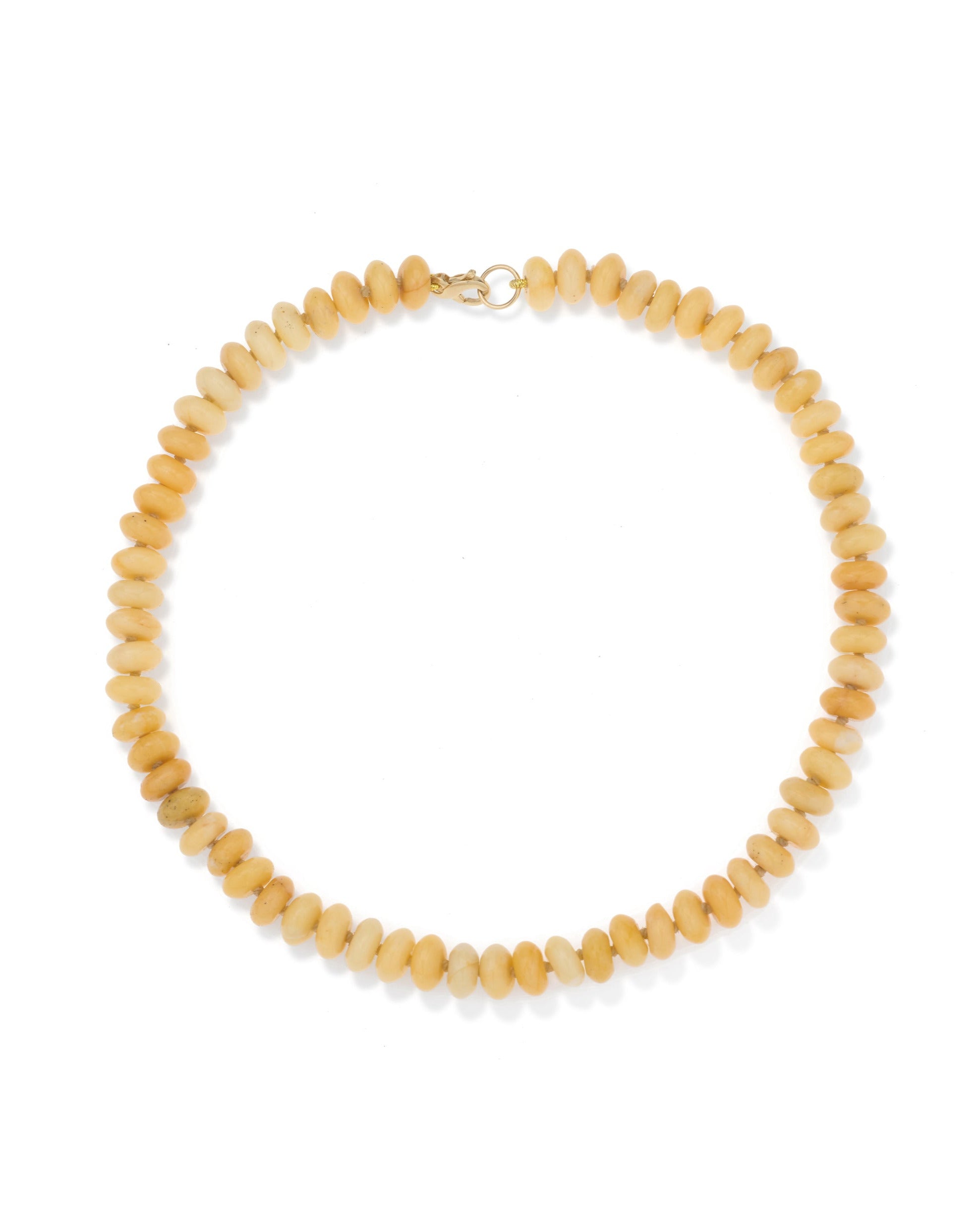 The Adina Reyter necklace draft features closely strung, oval light brown beads in a circular design and is finished with a small metal clasp at the top center.