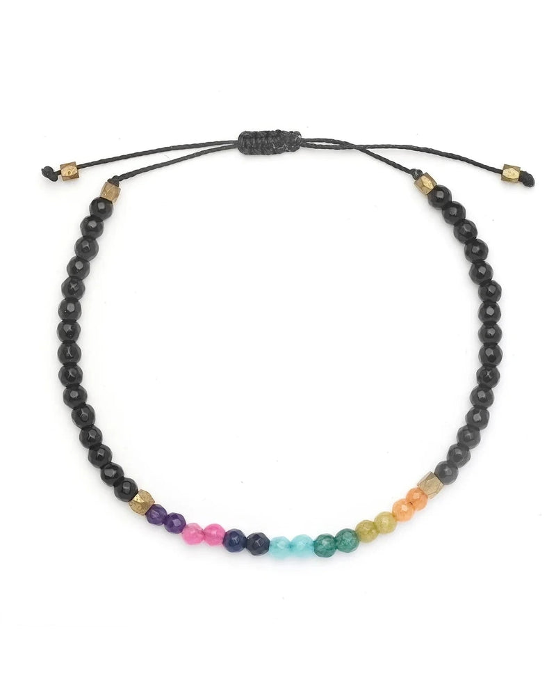 The Oiya Women’s Seven Chakras Bracelet is a black beaded adjustable bracelet, featuring colorful chakra beads and gold accents for a vibrant look.