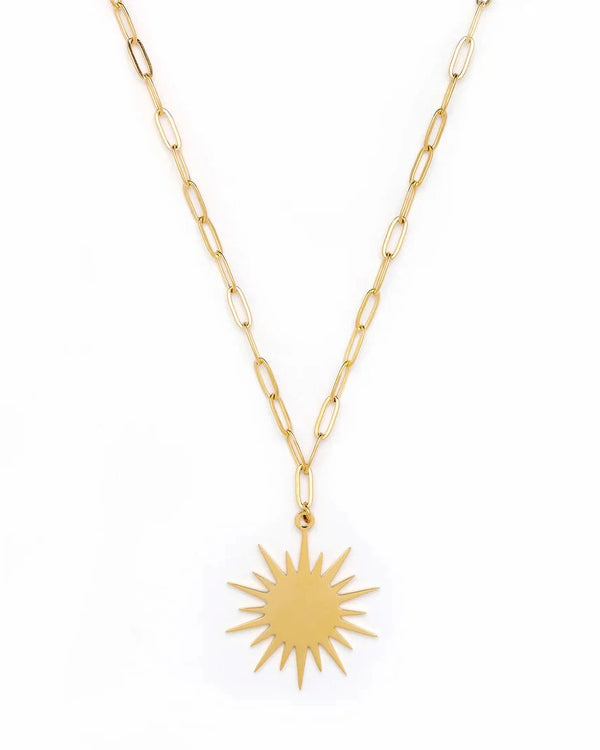 The Leilani Sun Chain Necklace by Oiya features elongated gold links and a sunburst pendant, displayed against a white background for a handmade, unique look.