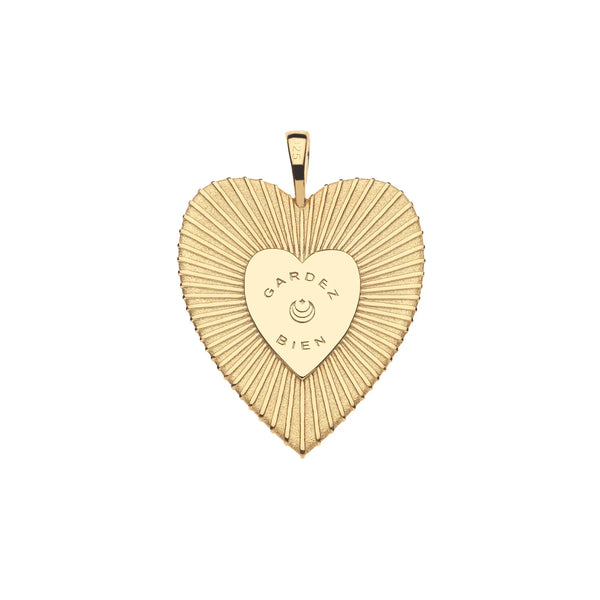 The Jane Win PROTECT Eye On Your Heart Pendant is a gold heart with a textured radiating pattern, GARDEZ BIEN engraved above a curved design, and a top bail for your chain—evoking classic evil eye protection.