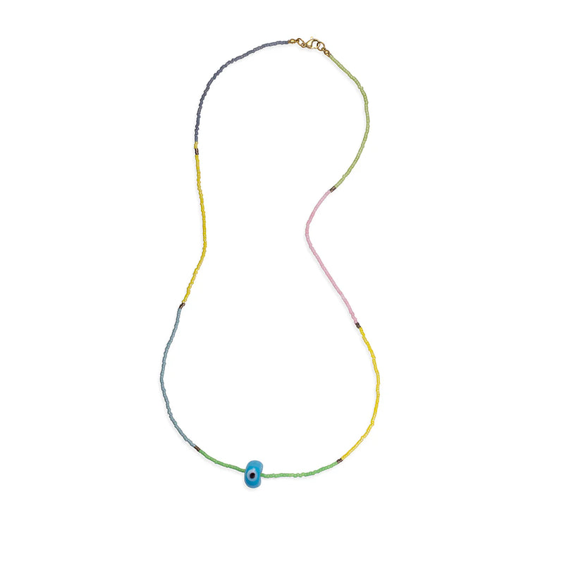 The Sandy Eye Necklace by Aaron Basha features multicolored beads in blue, yellow, pink, and green with a ceramic eye amulet and vermeil clasp, elegantly displayed in an open loop on a white background.