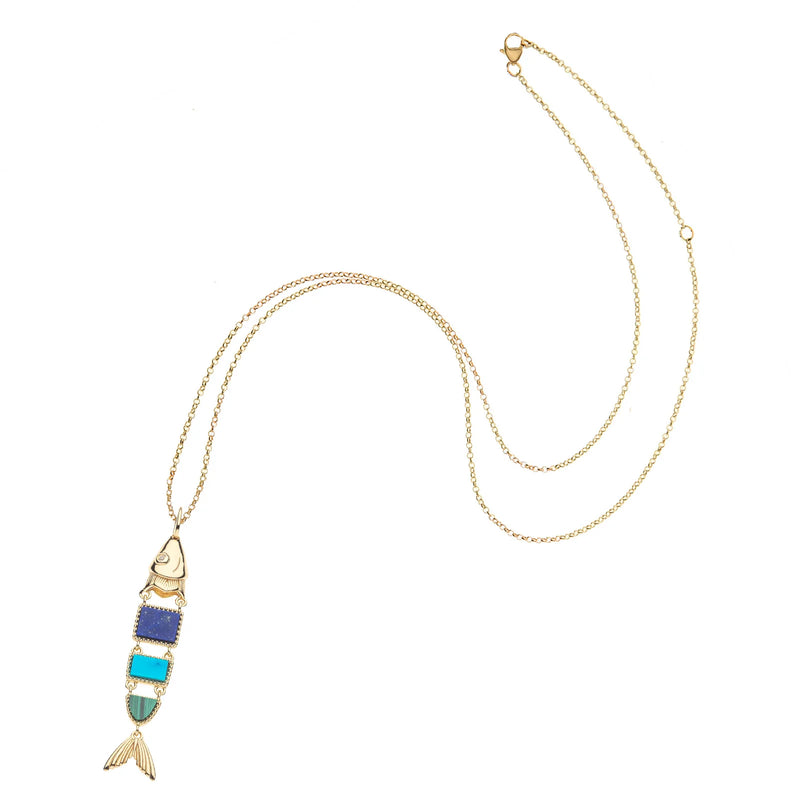 The STRONG Carpe Diem Fish Pendant by Jane Win is a gold chain necklace with a gold-plated, stylized fish pendant featuring blue, turquoise, and light green enamel—a unique piece of vintage-inspired jewelry.