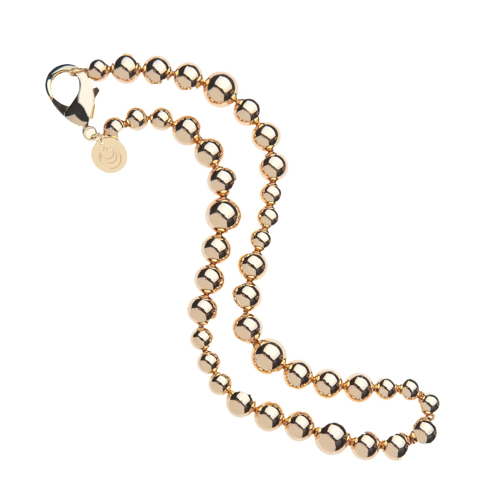 The Sun Reflection Beaded Necklace by Jane Win features 14k gold plating, a lobster clasp, and a small round charm, displayed in a loose S-shape on a white background.