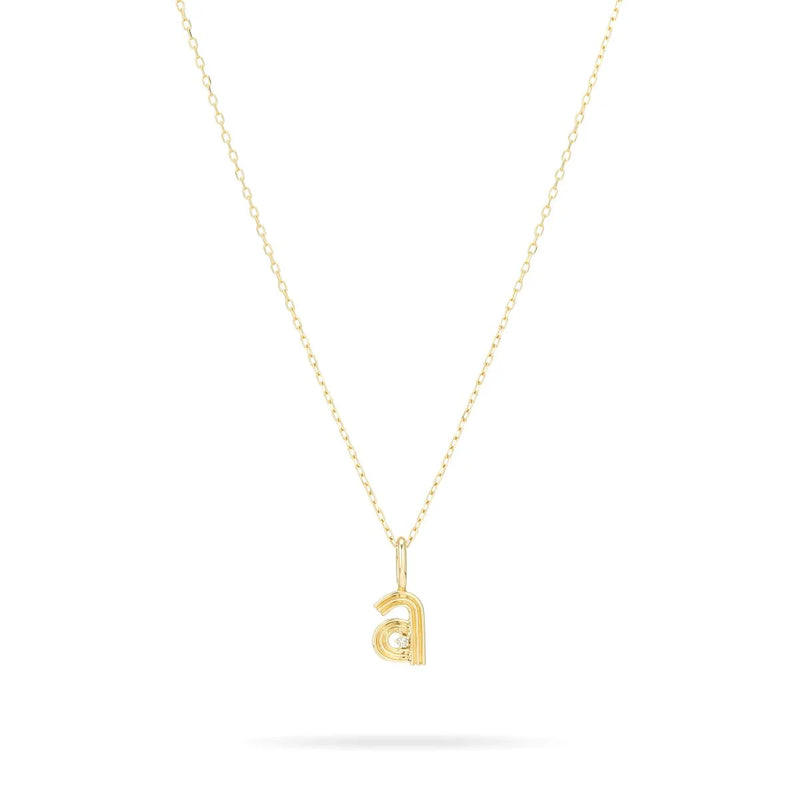 Adina Reyter's Groovy Diamond Initial Mini Bead Charm is elegantly showcased on a delicate 9K yellow gold chain necklace. The thin, minimalist design highlights a pendant shaped like a lowercase letter d, embodying subtle sophistication with its charming simplicity.