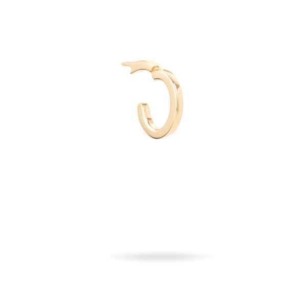 The Oval Charm Clip by Adina Reyter is a 14k yellow gold hoop earring with a polished finish, featuring a unique thick-to-thin design. It sits against a white background with subtle shadow, exuding timeless elegance.