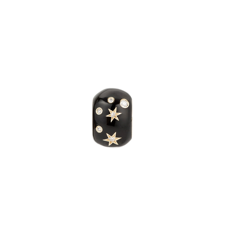The Adina Reyter Zodiac Ceramic + Diamond Capricorn Big Bead is a black ceramic ring adorned with two gold stars and three small, round white gemstones, shown against a white background.