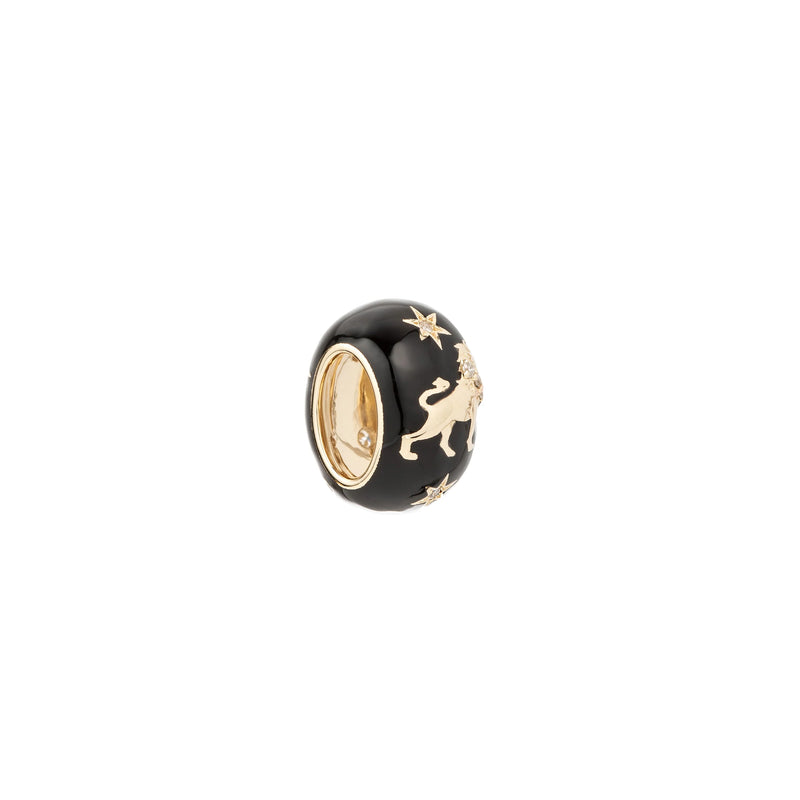 The Adina Reyter Zodiac Ceramic + Diamond Leo Big Bead features a round black design with gold lion and star accents, a gold-tone interior, and is shown on a plain white background.