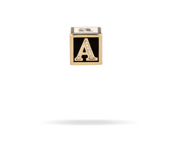 A Ceramic + Pavé Initial Block Big Bead by Adina Reyter, featuring a gold and black cube adorned with pavé diamonds and the letter A engraved on the front face, set against a white background.