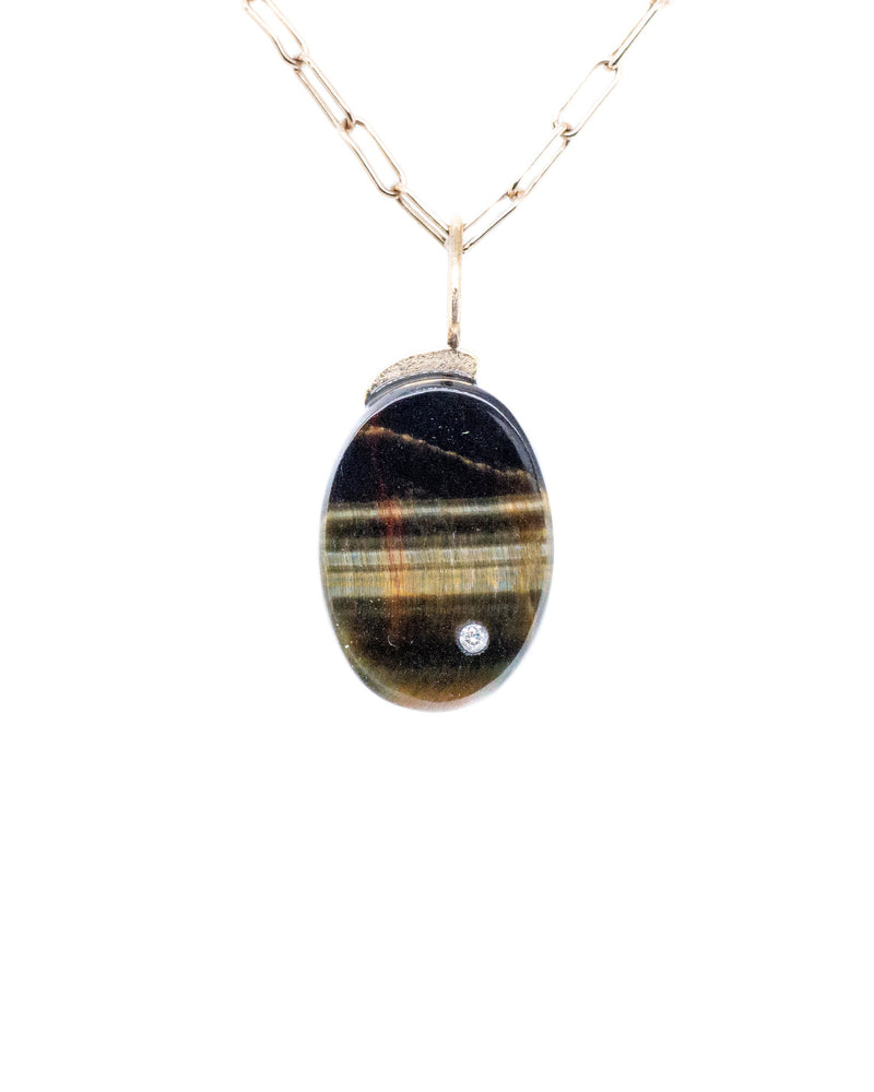 Blue Tiger Oval Charm by Karen Luvaas: an oval pendant with a multicolored striped stone set in gold, accented with a small diamond and hanging from a delicate elongated-link gold chain, shown on a white background.