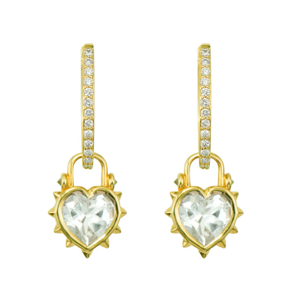 The Thorned Jewel Heart Charm by Three Stories Jewelry features a heart-shaped clear gemstone in a spiked frame, accented with pavé diamonds on 14K yellow gold hooks—perfect with statement links or a bold paperclip chain.