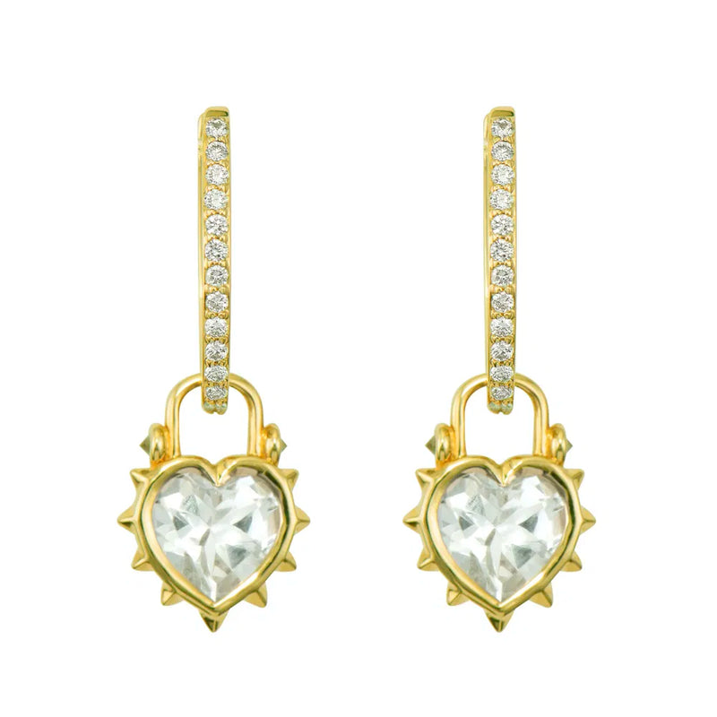 The Thorned Jewel Heart Charm by Three Stories Jewelry features a heart-shaped clear gemstone in a spiked frame, accented with pavé diamonds on 14K yellow gold hooks—perfect with statement links or a bold paperclip chain.