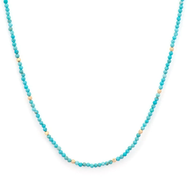 The Delicate Turquoise Beaded Chain 18 by Three Stories Jewelry features small turquoise and 14k gold beads with beige accents in a subtle pattern, enhanced by an adjustable chain for the perfect fit.