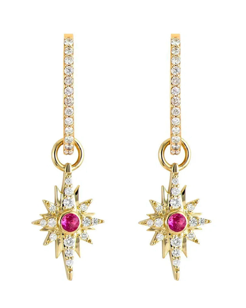 Three Stories Jewelry presents Small Shooting Star Charms: gold hoops with starburst designs in 14K yellow gold, featuring a central red gemstone surrounded by diamonds and sparkling clear stones for an exquisite, timeless allure.
