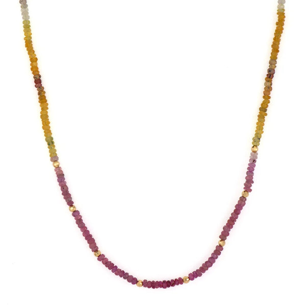 The Delicate Multi-Colored Sapphire Beaded Chain 18 by Three Stories Jewelry features a gradient of yellow, orange, pink, and purple beads with 14K gold accents. Small gold-colored details separate the beads, and an adjustable chain allows for versatile wear.