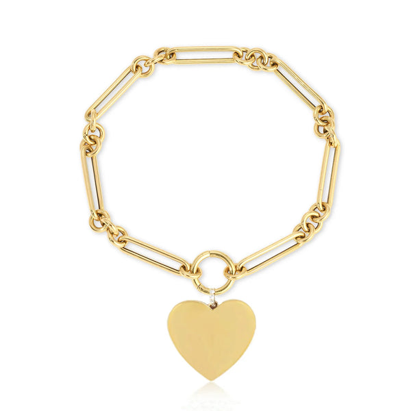 The ef collections Gold Jumbo Heart Charm Bracelet showcases a heart-shaped pendant on elongated links, creating a modern and elegant look. Perfect for engraving, the charm hangs from a circular link, adding romance to the design.