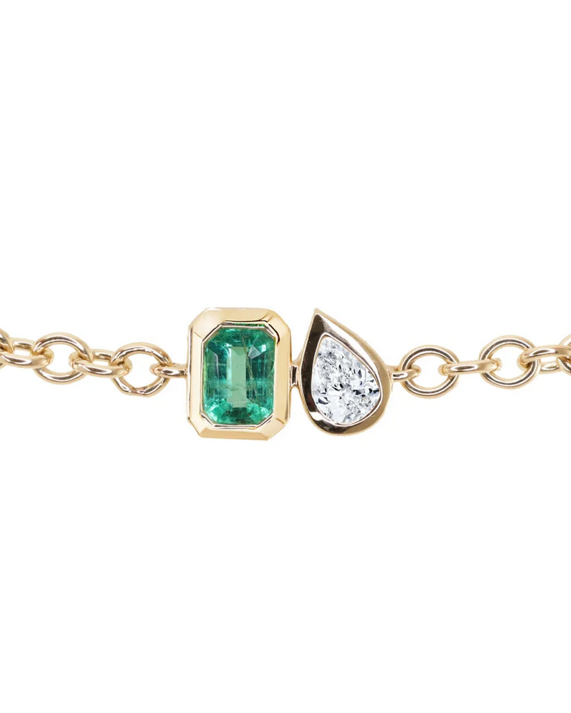 The Luna Skye 14kt gold diamond and emerald duo bezel bracelet features an emerald-cut green emerald and a teardrop diamond set side by side in gold bezels for an elegant look.