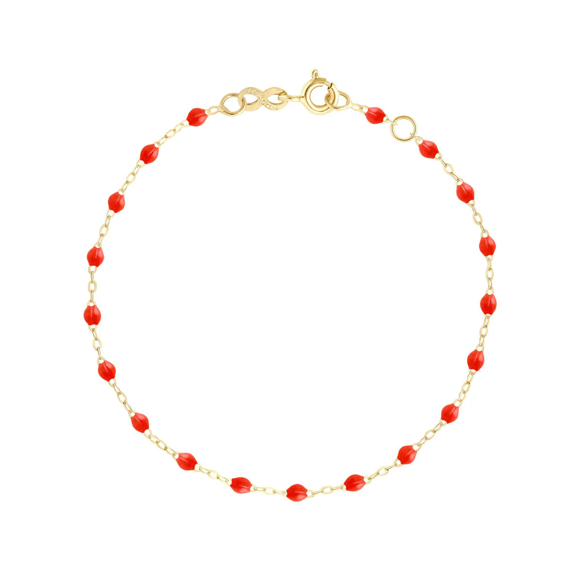 A delicate Classic Gigi Bracelet by Gigi Clozeau, crafted from 18k gold and adorned with small, evenly spaced red beads. This elegant piece is handmade in France and showcased on a plain white background, featuring an adjustable lobster clasp closure.