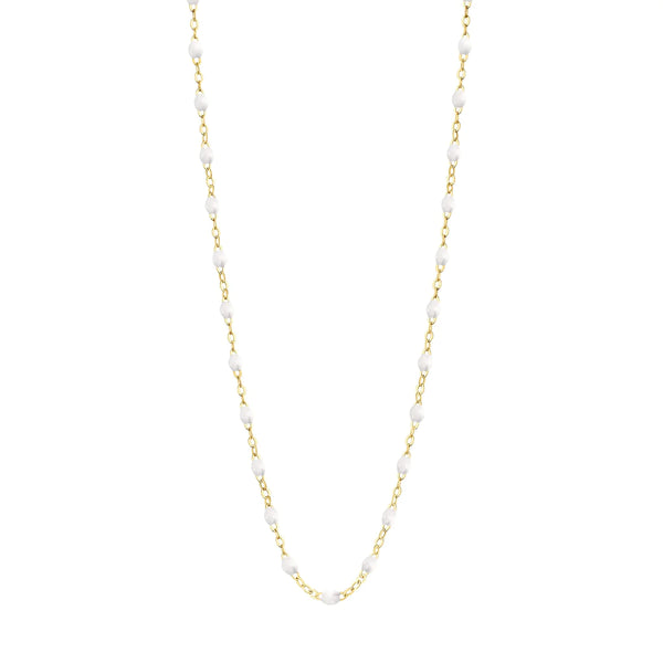 Discover the Classic Gigi 16" Necklace by Gigi Clozeau, featuring a delicate gold chain accented with small, evenly spaced white pearls. As part of our exclusive collection, each piece is meticulously handmade to embody timeless elegance.