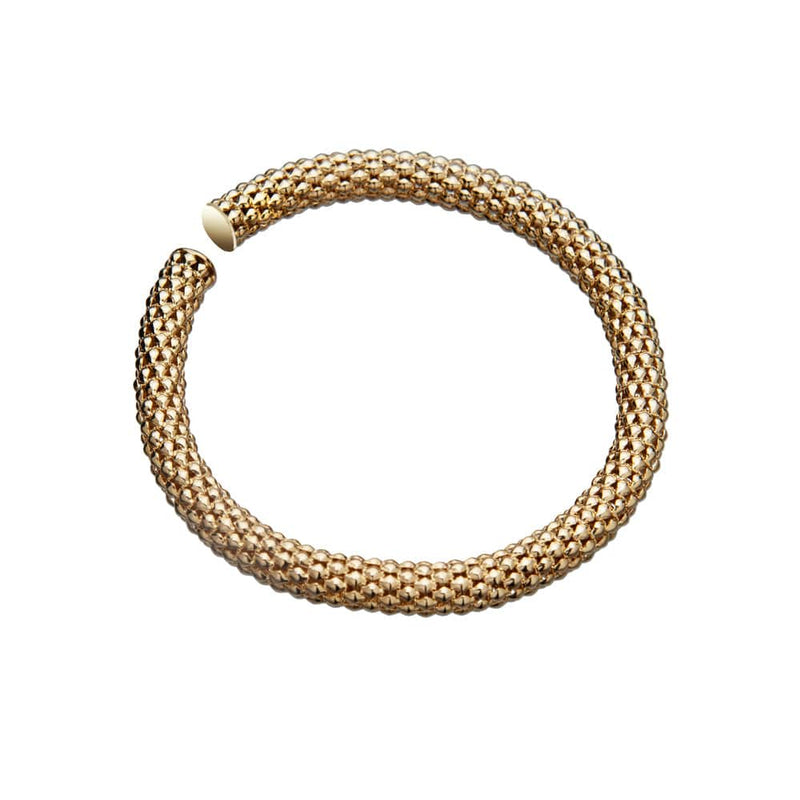 The Aisha Bracelet by Jennifer Zeuner, a gold vermeil, textured, open-ended piece resembling a coiled mesh tube with intricate woven detailing, exudes classic glamour. Showcased on a white background, its design captures the essence of timeless elegance.