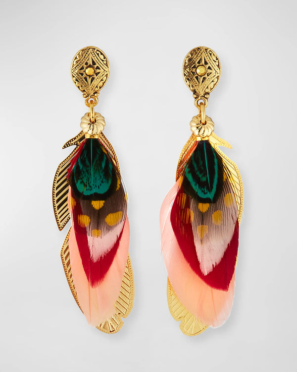 The Sao Feather Drop Earrings by gas bijoux feature ornate, gold-plated brass circular tops with vibrant feather drops in green, red, and yellow hues. These exquisite earrings are adorned with intricate leaf-shaped gold accents for added elegance.