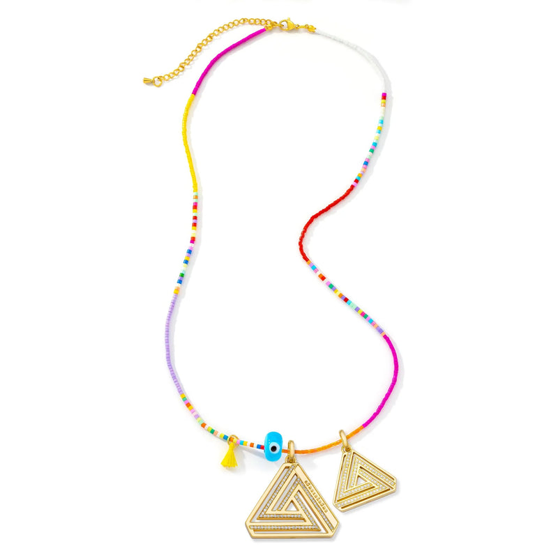 The Aaron Basha Small Abracadabra Triangle Series 4 features a colorful necklace with small multicolored beads, a yellow tassel, a blue evil eye bead, two gold triangular pendants with intricate designs symbolizing empowerment and inner strength, and a gold adjustable clasp.