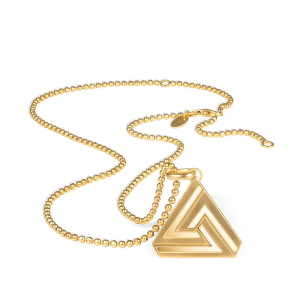 The Aaron Basha Small Abracadabra Triangle Simple Series 1 is an 18K gold-plated necklace with a ball chain and a triangular pendant featuring an abstract interlocking design, symbolizing inner strength, elegantly displayed on a white surface.