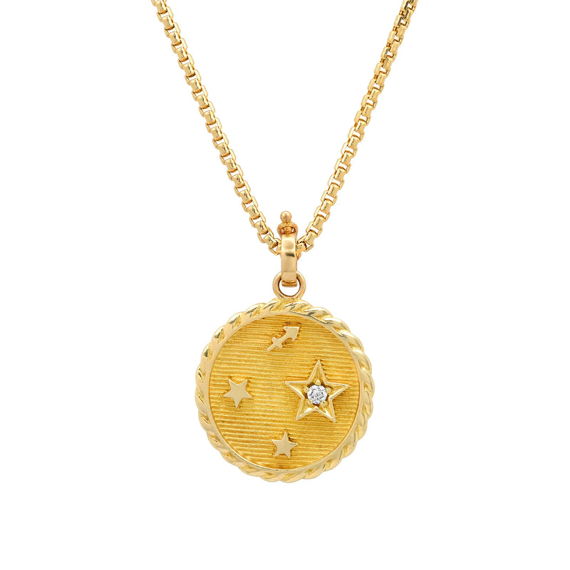 The Helena Rose Small Zodiac Necklace features a 14K yellow gold chain and a round, textured zodiac pendant with engraved stars, a central diamond-set raised star, and a twisted rope border.
