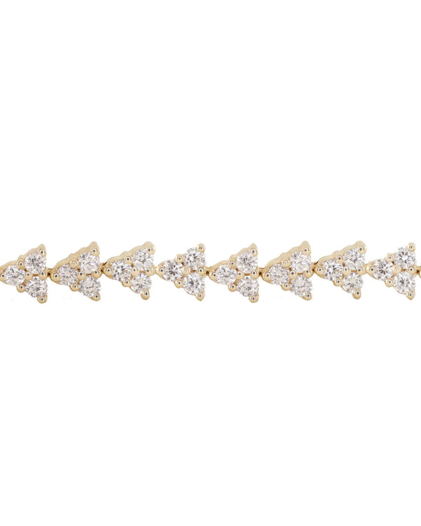 The Luna Skye 14kt gold full three diamond cluster tennis bracelet features repeating clusters of sparkling diamonds, capturing the elegance of a classic diamond bracelet, beautifully displayed on a plain white background.