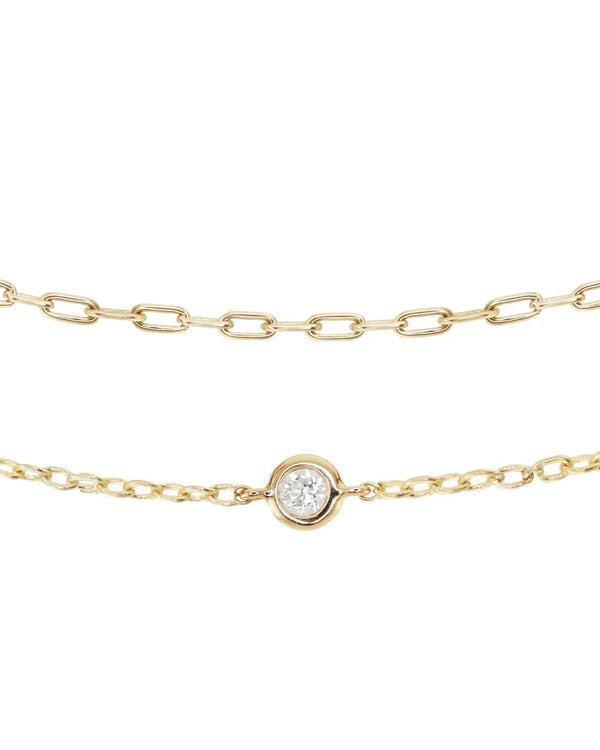 Two delicate gold chain necklaces—one with oval links, the other featuring a round diamond bezel—pair beautifully with the Luna Skye 14kt gold two row diamond bezel chain bracelet or your favorite tennis bracelet.